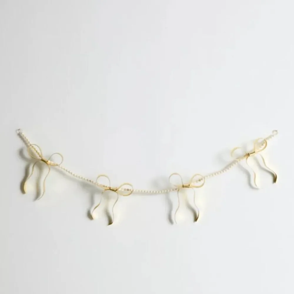 Eloise Pearl & Bow Banner from Urban Outfitters Outfit Your Dorm Back to School